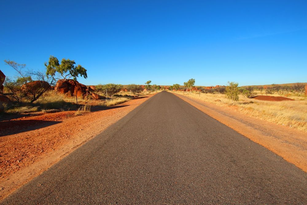 Black Asphalt Road Through Arid Landscape with Blue Sky — Wendy's Safety Services In Tennant Creek, NT