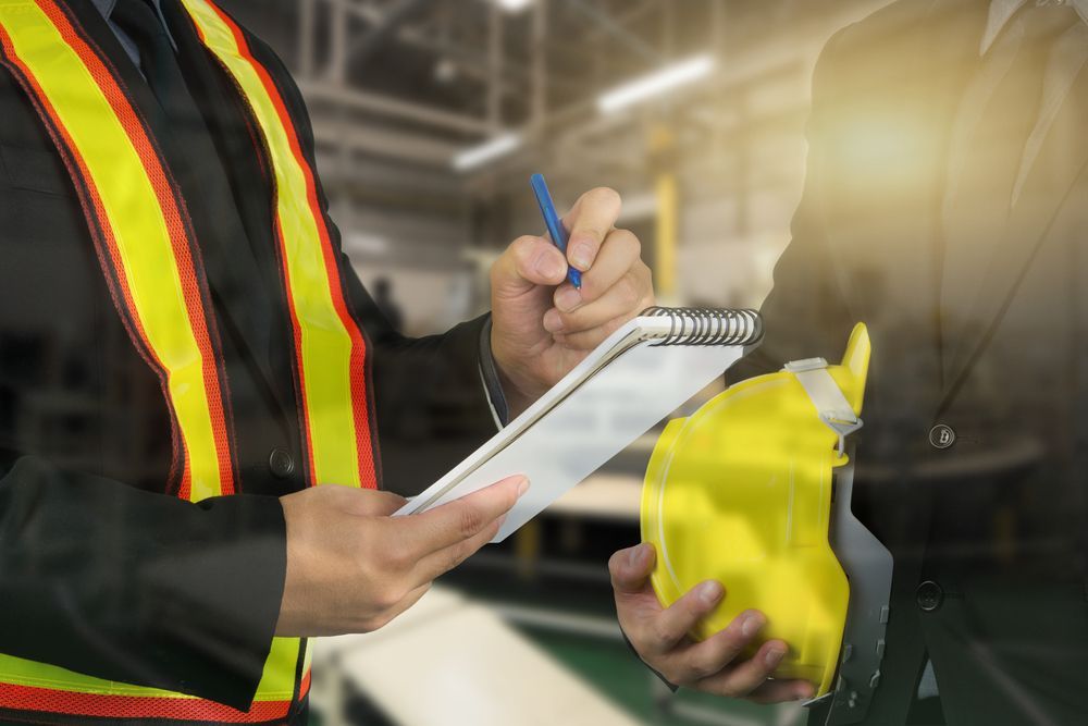 Person in Safety Vest Taking Notes While Examining — Wendy's Safety Services In Tennant Creek, NT