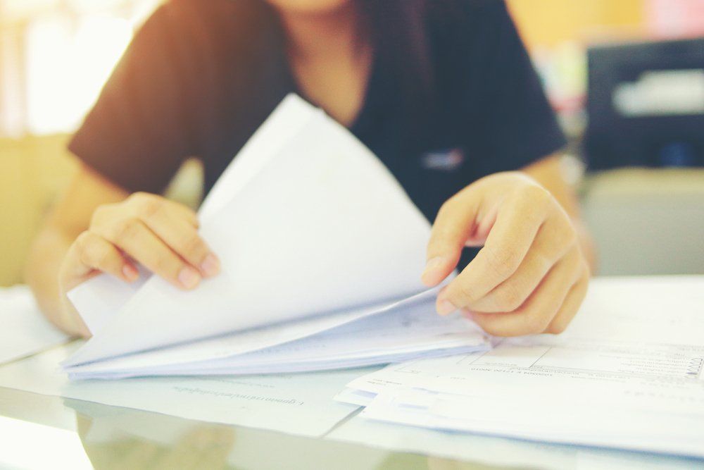 Female Worker Arranging Documents — Wendy's Safety Services In Moulden, NT
