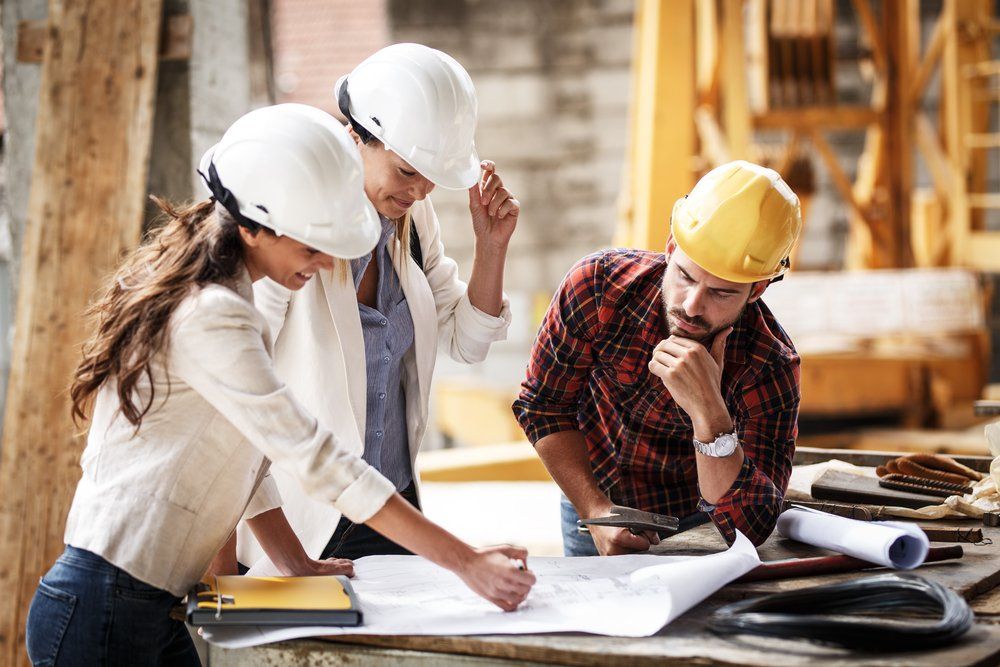Two Female Inspectors with An Architect Discussing a Construction Project  — Wendy's Safety Services In Moulden, NT
