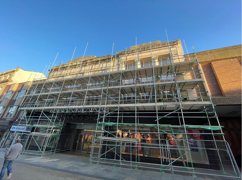 A large building with scaffolding on the side of it.