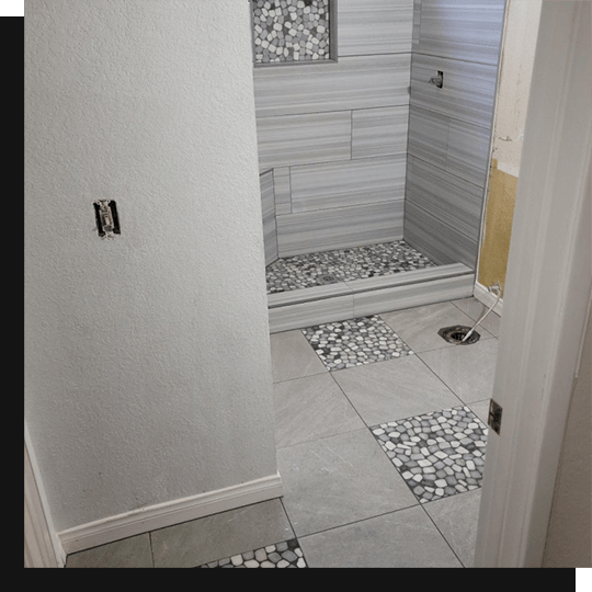 Interior of residential bathroom with gray tiles