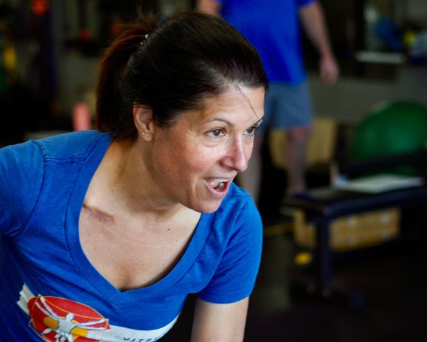 Close-up of woman focused on strength training activity with blurred background