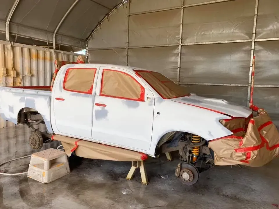 White Pickup Truck in a Paint Booth, Masked With Brown Paper, Primed for Painting — All Blast and Paint in Bakers Creek, QLD