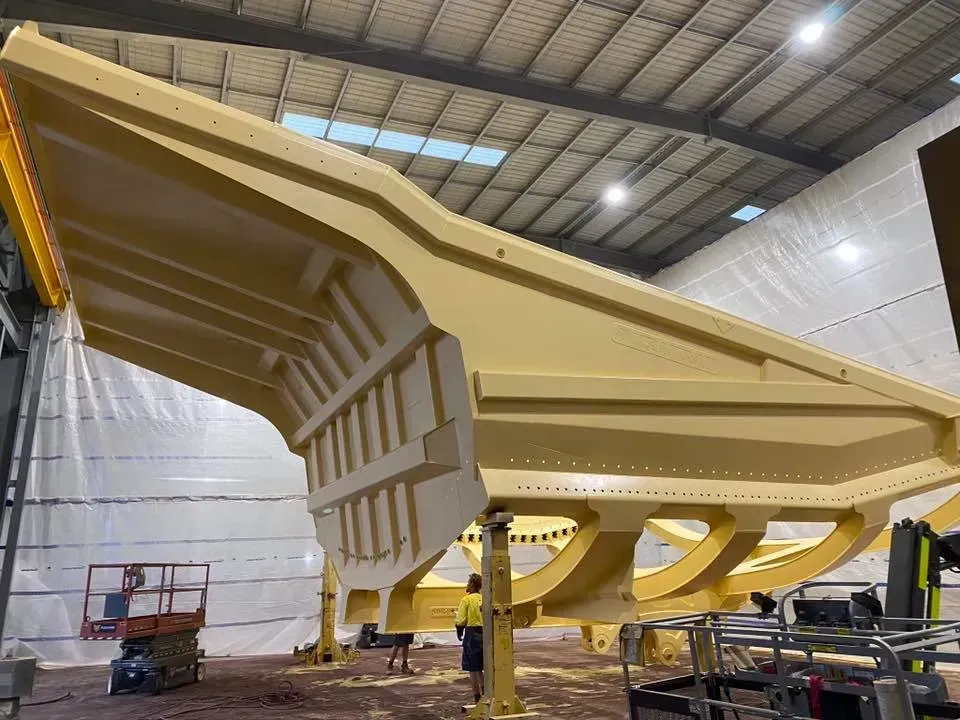 Large, Yellow Industrial Mining Truck Component Inside a Factory — All Blast and Paint in Bakers Creek, QLD