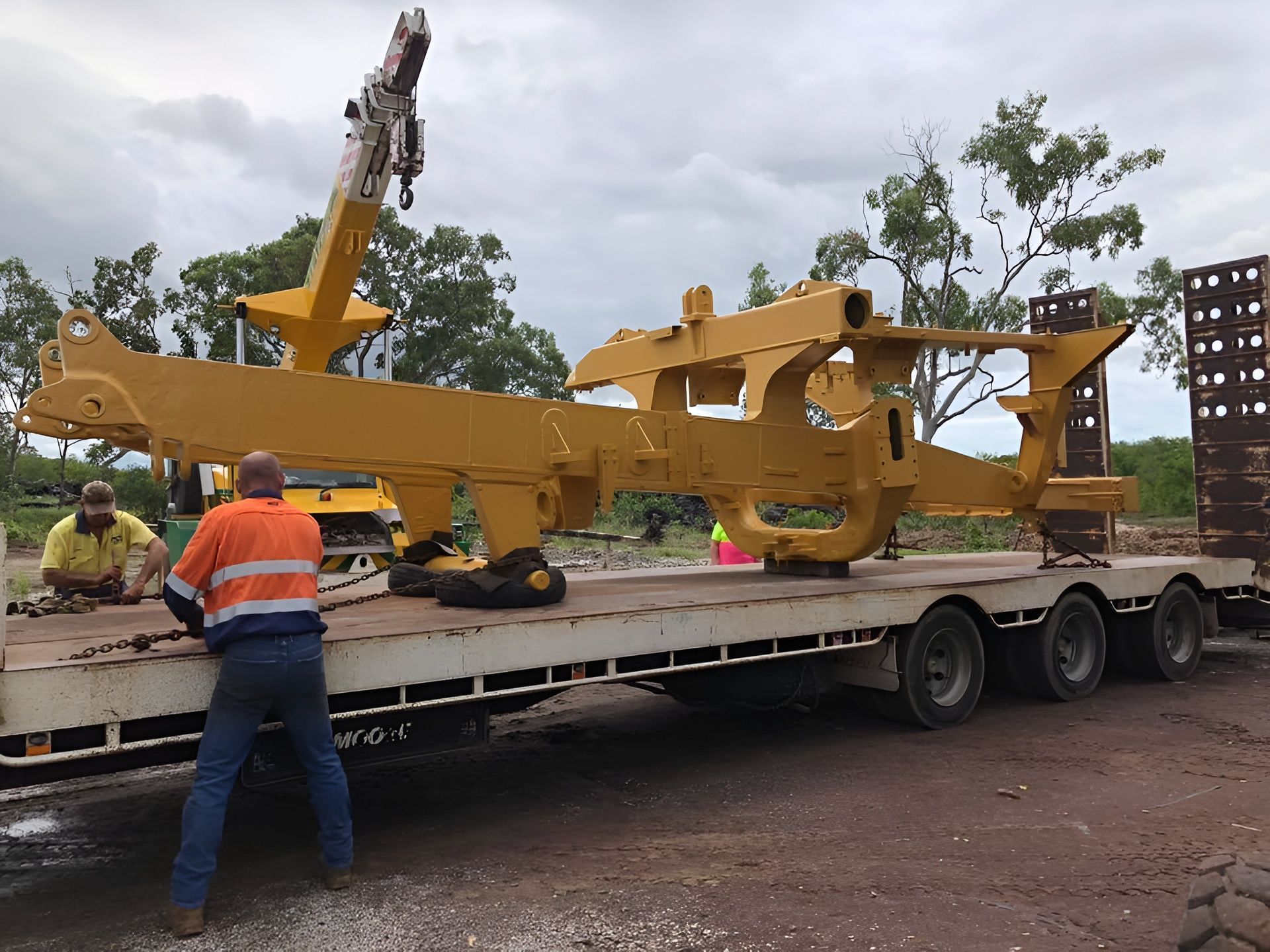 Yellow Heavy Equipment Frame Loaded on a Flatbed Trailer — All Blast and Paint in Bakers Creek, QLD