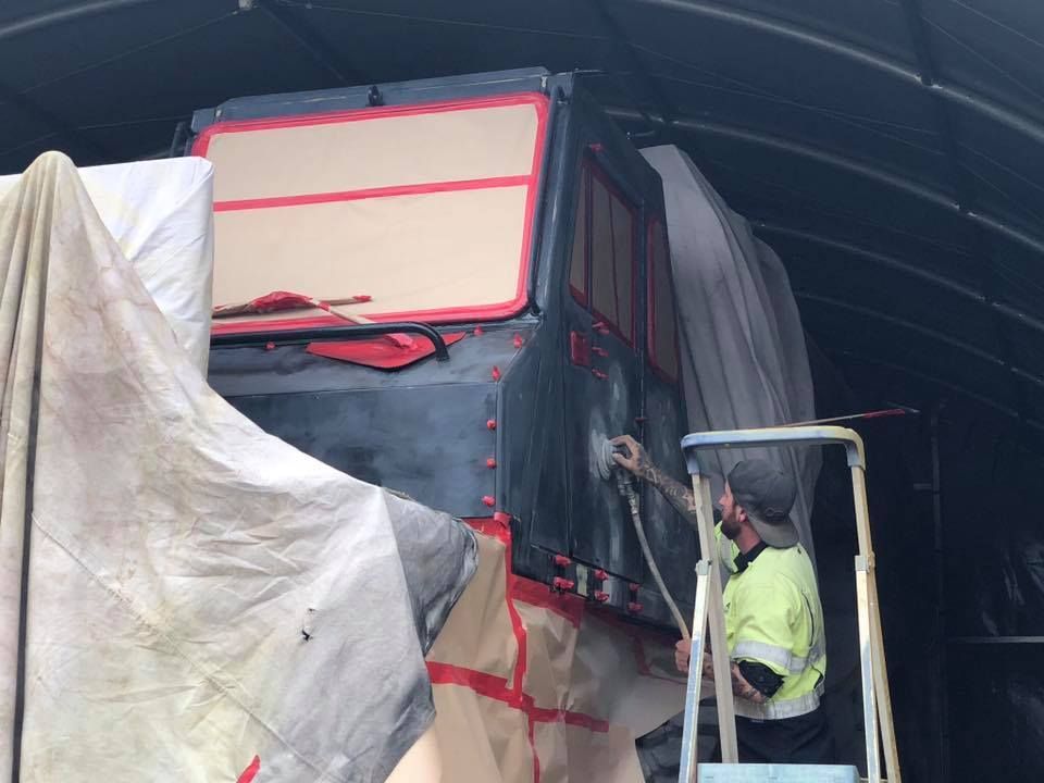 A Person on a Ladder Sprays Paint on a Truck Cab — All Blast and Paint in Bakers Creek, QLD
