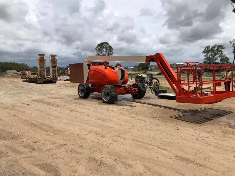 Orange Boom Lift on Gravel, Extended Towards the Right — All Blast and Paint in Marian, QLD
