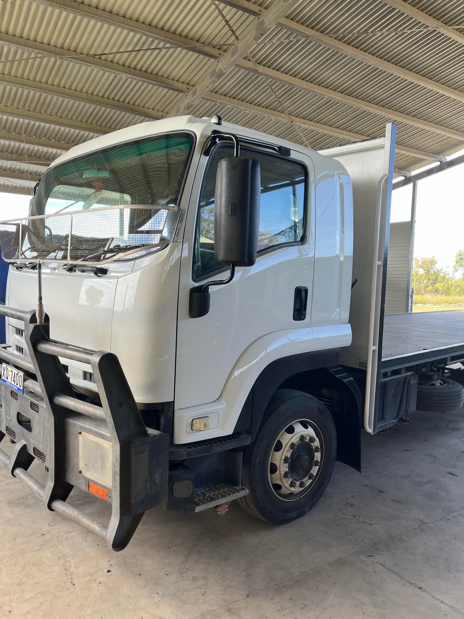 White Flatbed Truck With a Bull Bar Parked Under a Covered Structure — All Blast and Paint in Bakers Creek, QLD