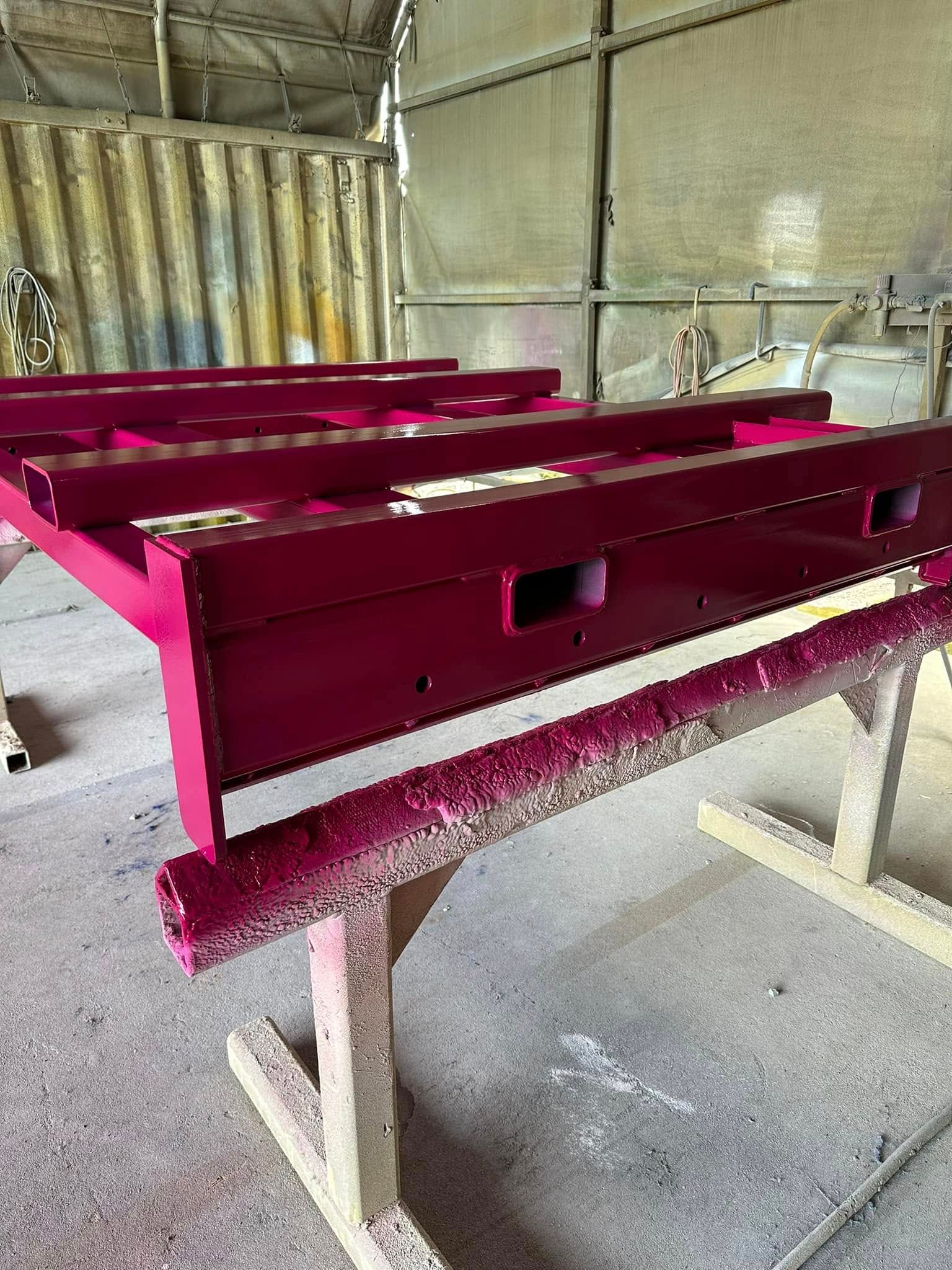 A Freshly Painted Magenta Metal Frame Rests — All Blast and Paint in Paget, QLD
