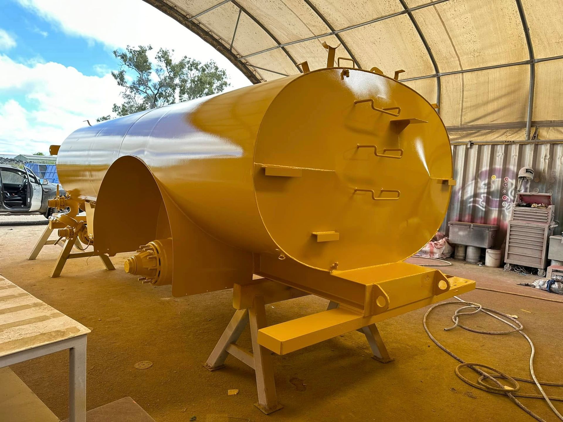 Yellow Tank Being Painted Inside a Workshop — All Blast and Paint in Paget, QLD
