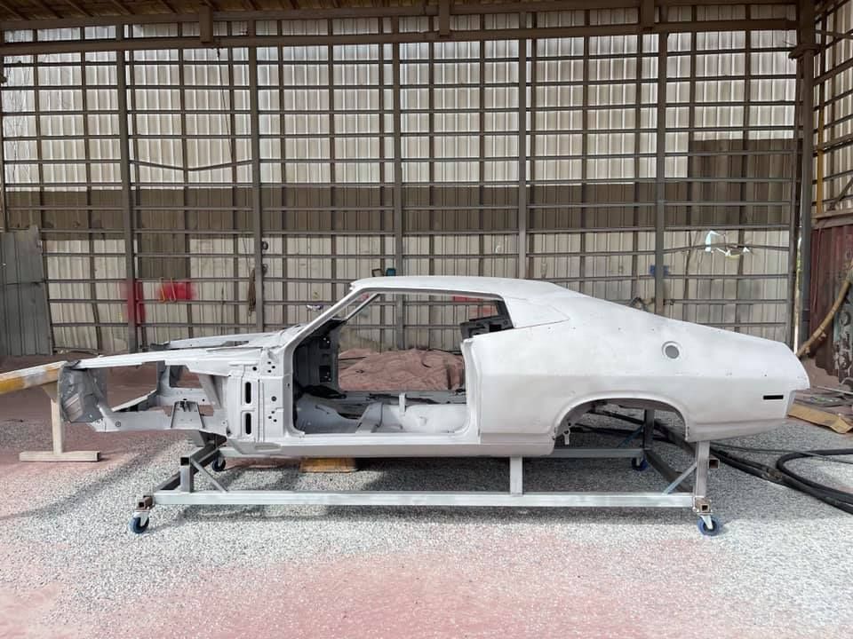 White Classic Car Body on a Wheeled Frame in a Workshop — All Blast and Paint in Bakers Creek, QLD