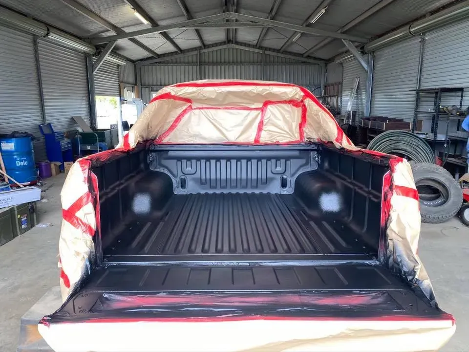 Truck Bed Being Painted Black Inside a Garage — All Blast and Paint in Bakers Creek, QLD