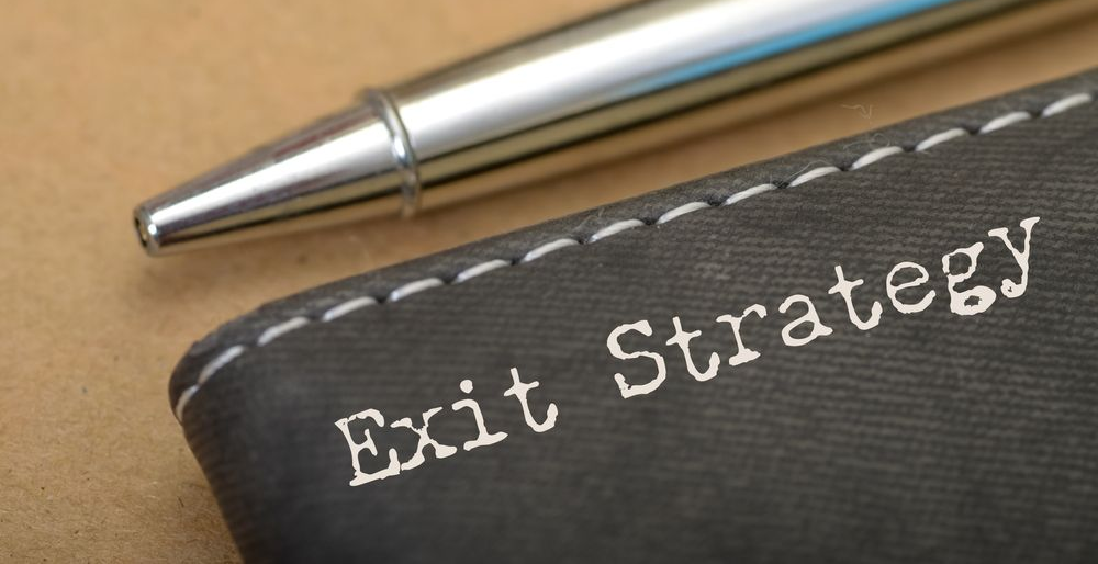 Close-up of a pen resting on a notepad with the words 