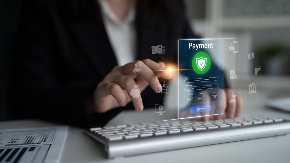 Person using keyboard, with holographic payment screen displaying security shield icon.