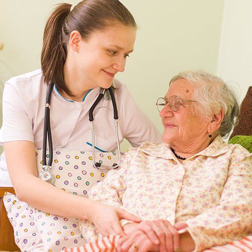 nurse with elderly woman at retirement center