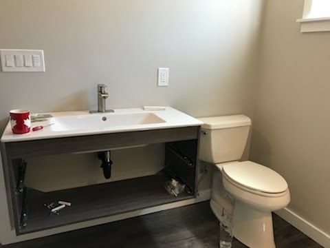 A bathroom with a sink and toilet in it.