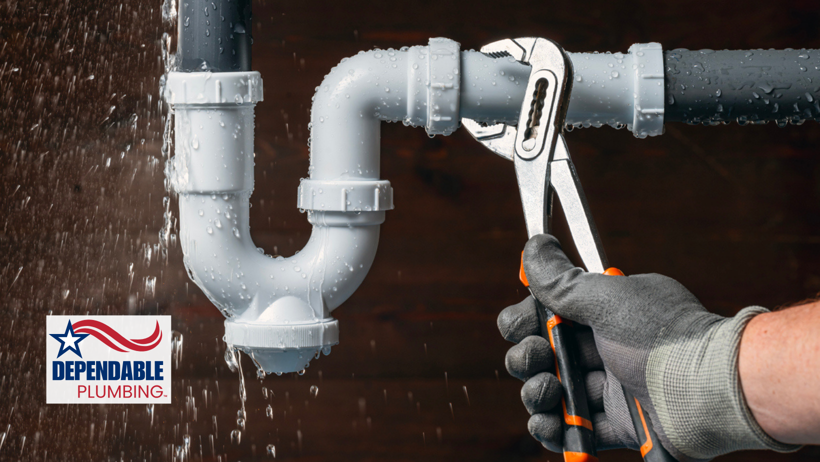 A gloved hand uses pliers on a leaking plumbing pipe. 