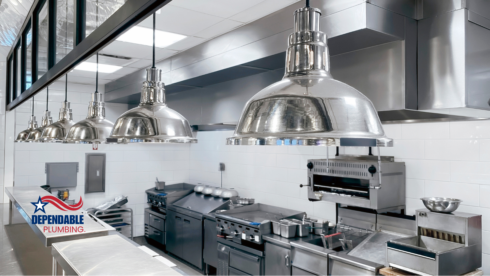 A kitchen with a lot of stainless steel appliances and a sign that says expensible plumbing.
