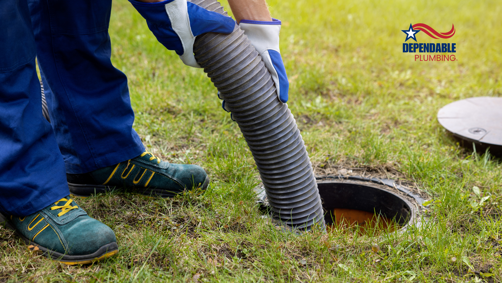 A man is pumping a hose into a septic tank.