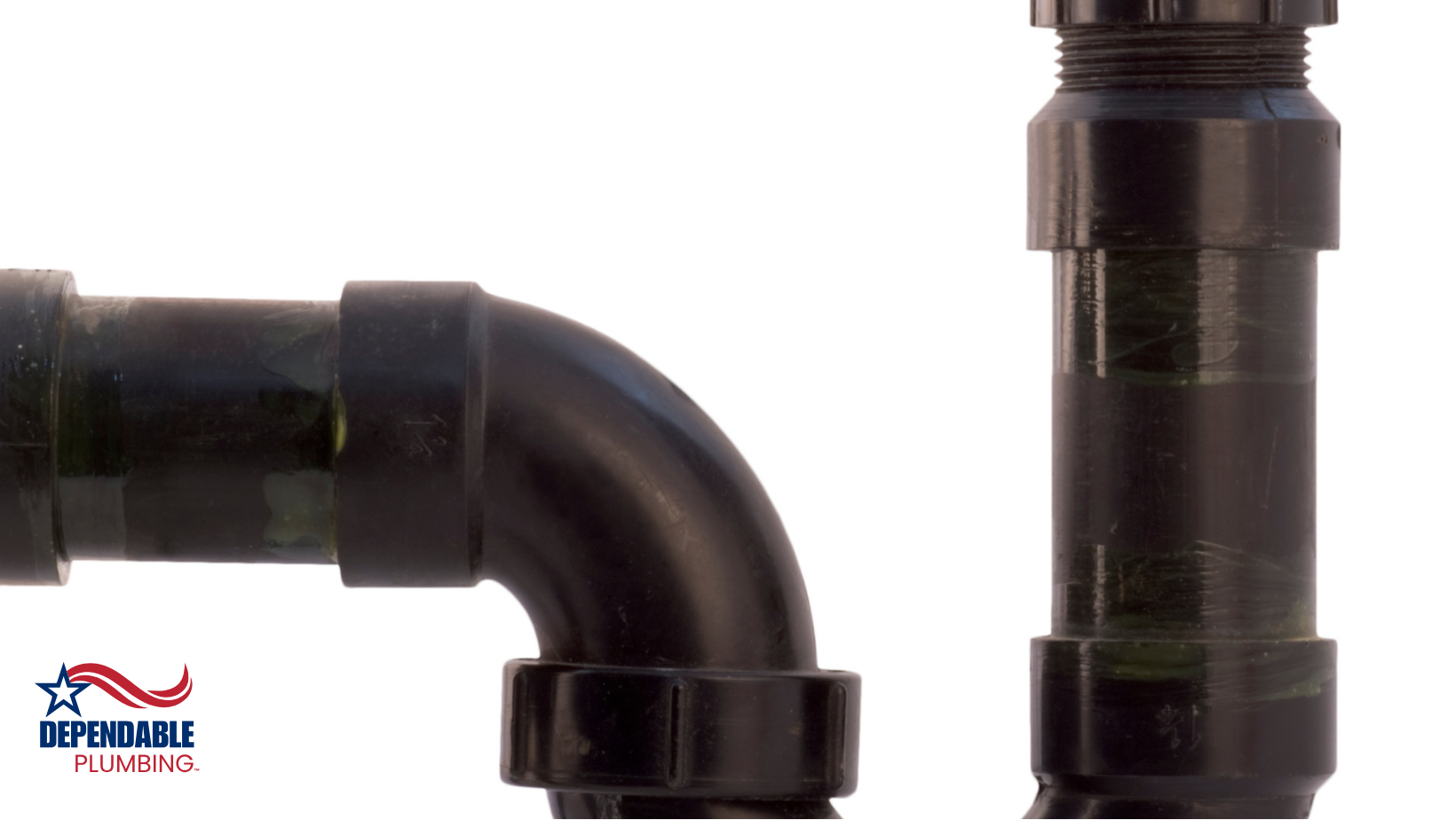 A close up of a black pipe on a white background, sewer line.