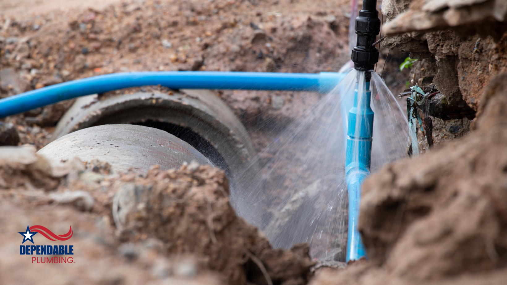 A blue pipe is coming out of a hole in the ground.