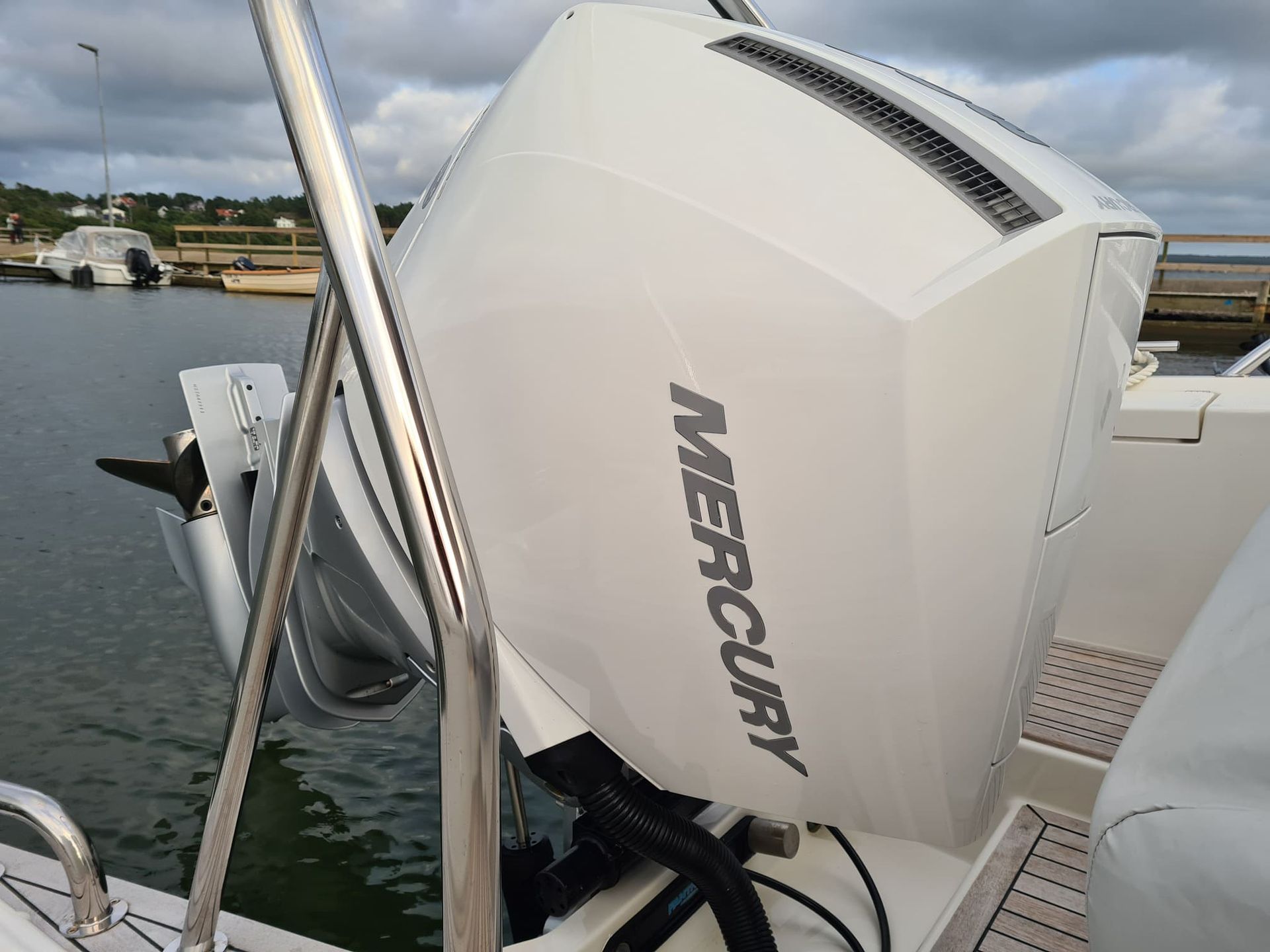 A white mercury outboard motor on a boat