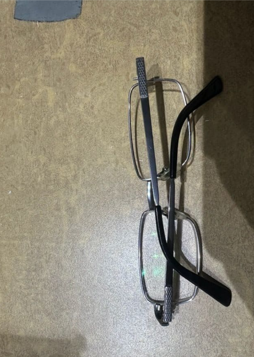 Silver-Framed Eyeglasses with Black Arms, Laying on A Tan Surface — Eyepower In Tahmoor, NSW