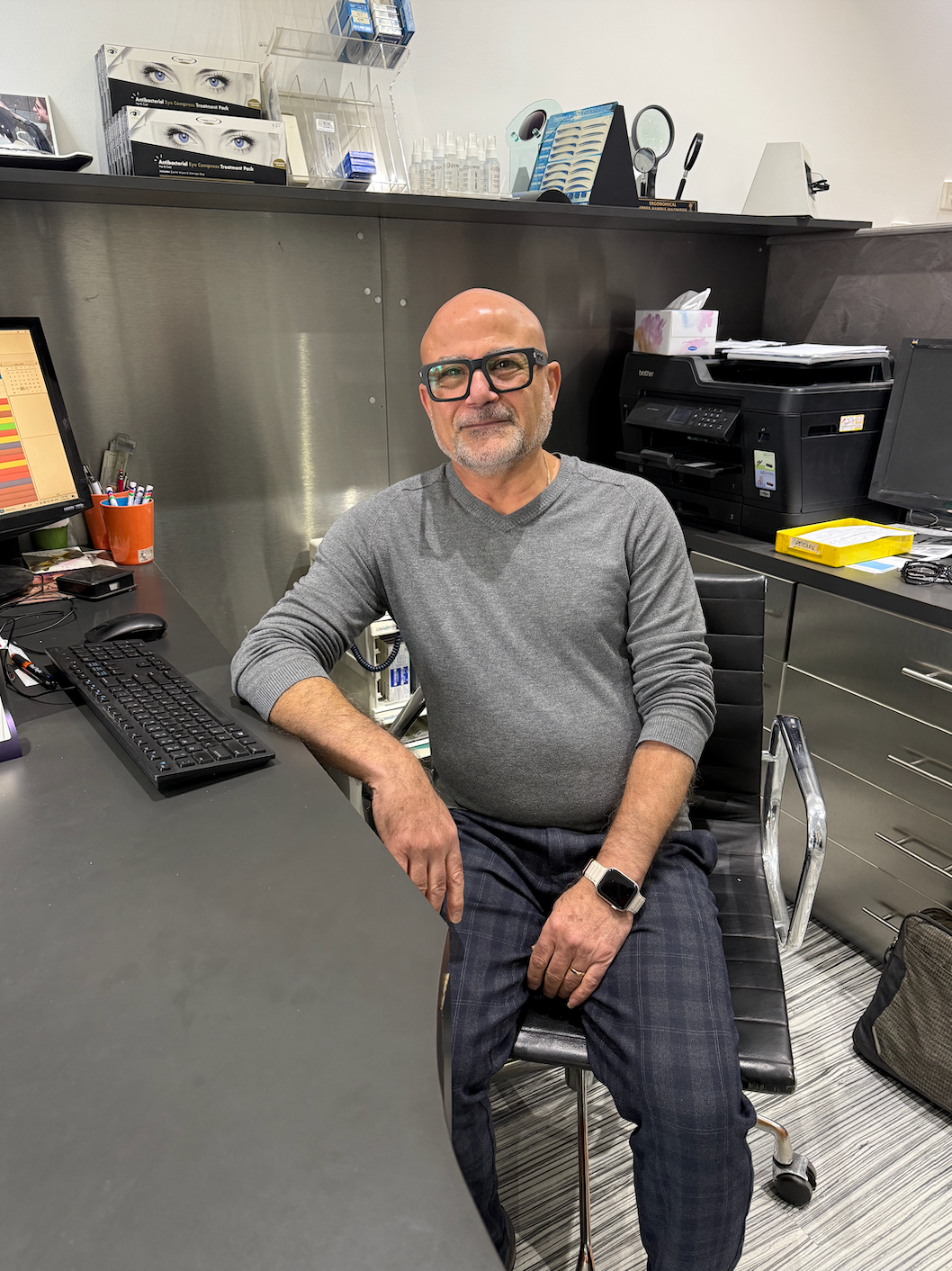 Man with glasses sits at a desk in an office — Eyepower In Tahmoor, NSW