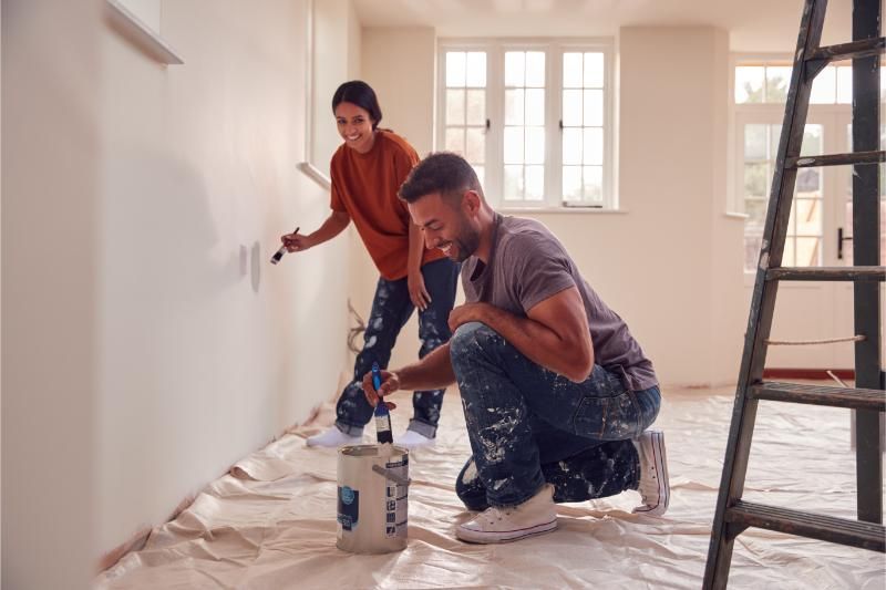 couple painting test squares on wall