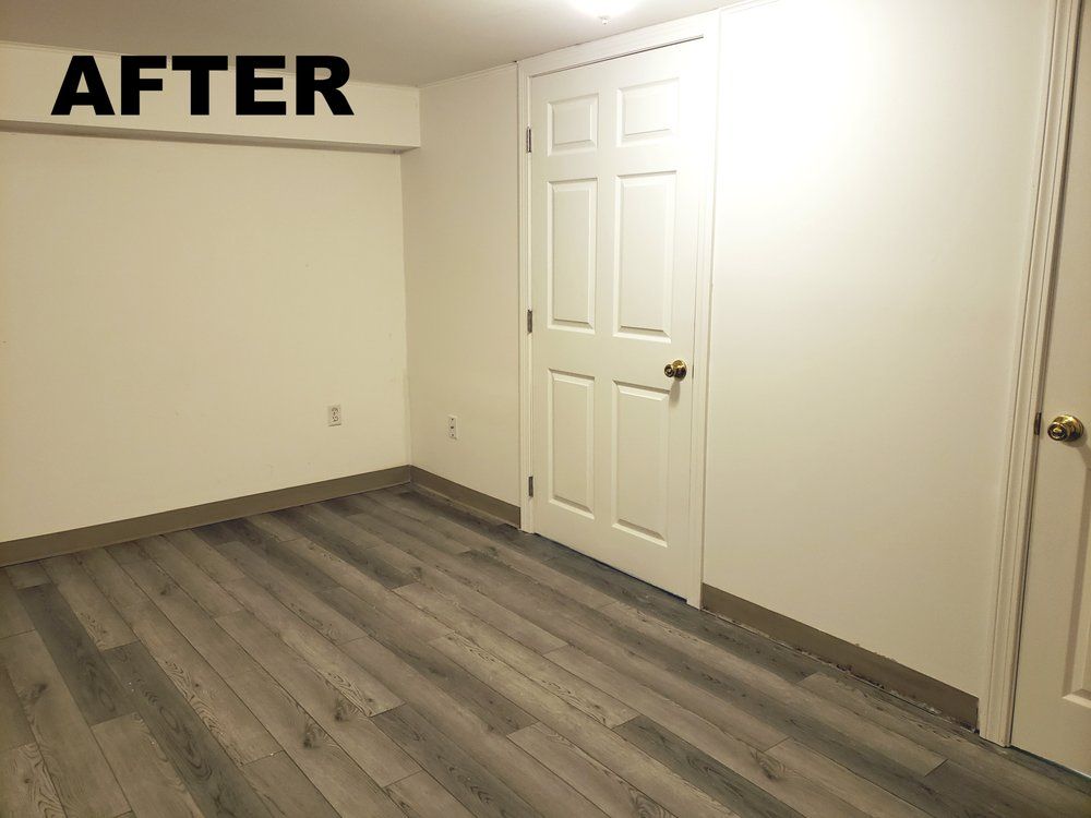 Empty room with gray wood flooring, white walls, and closet doors, labeled “AFTER” in the top left.