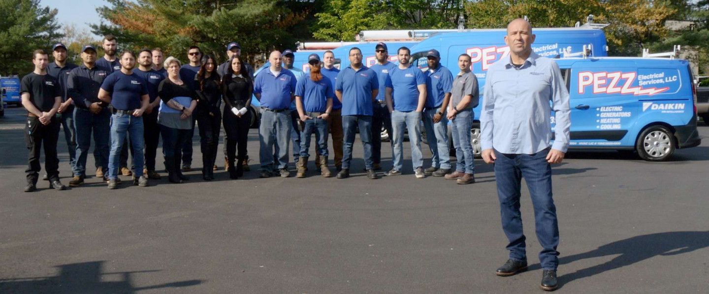 A man is standing in front of a large group of people.