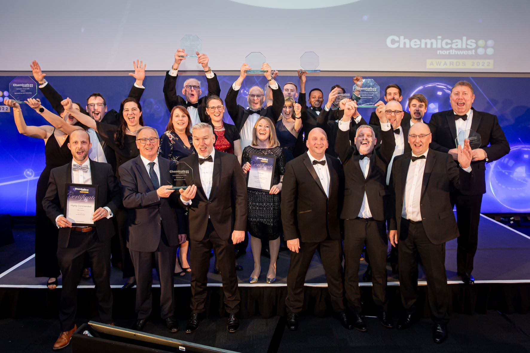 group shot of all the winners with their trophies and certificates on stage at the CNW awards