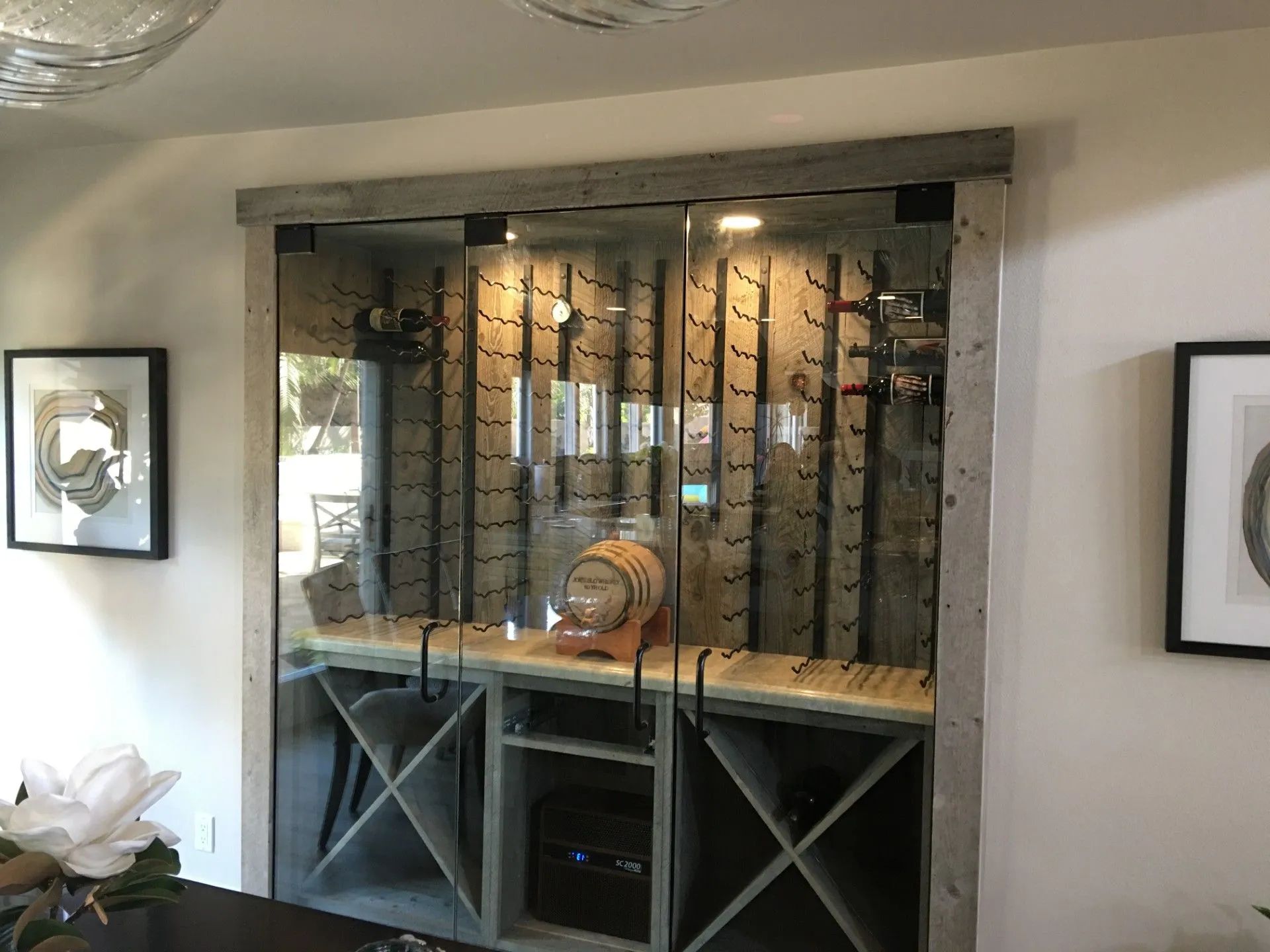 Wooden wine cabinet with bottles and wine storage, illuminated with soft lighting. Wooden wine cabinet with bottles and wine storage, illuminated with soft lighting.