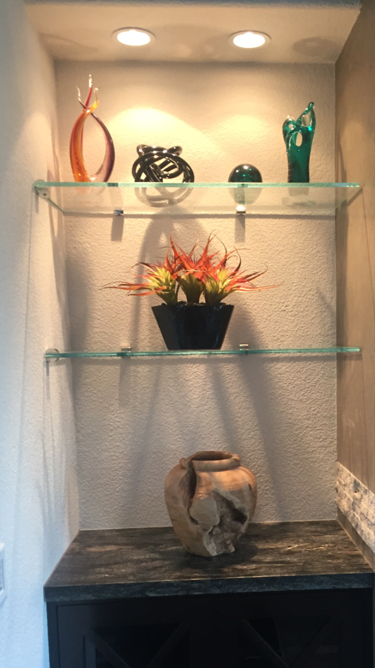 Wooden wine cabinet with bottles and wine storage, illuminated with soft lighting.