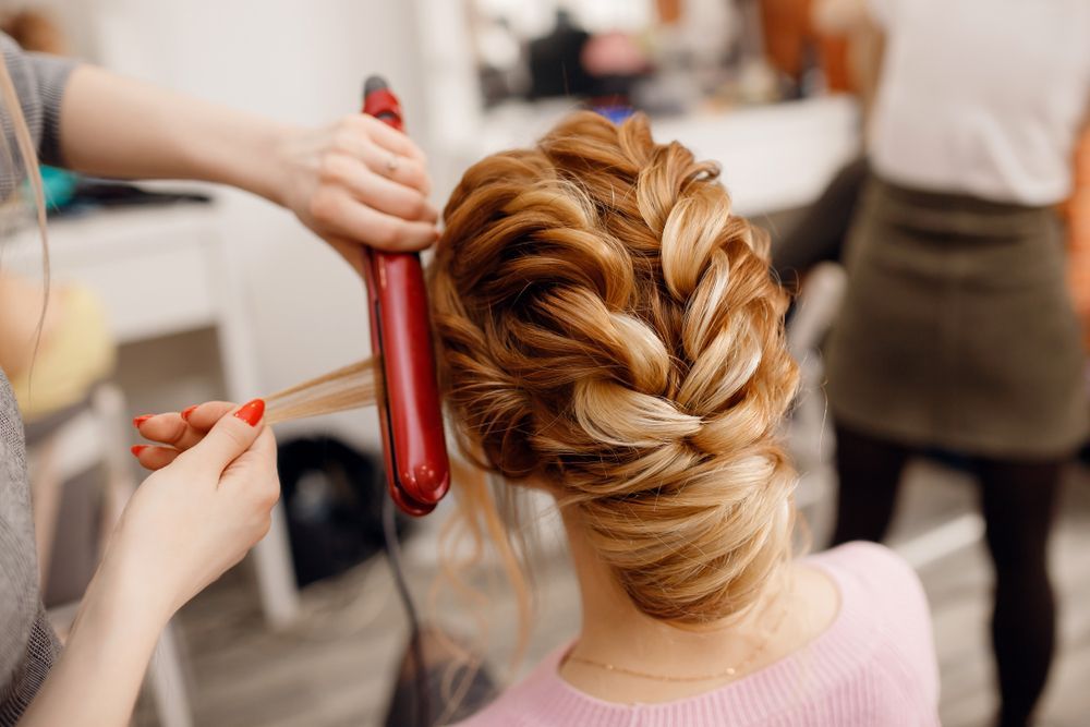 A Woman is Getting Her Hair Done by a Hairdresser in a Salon — Hair It Is In Balgownie, NSW