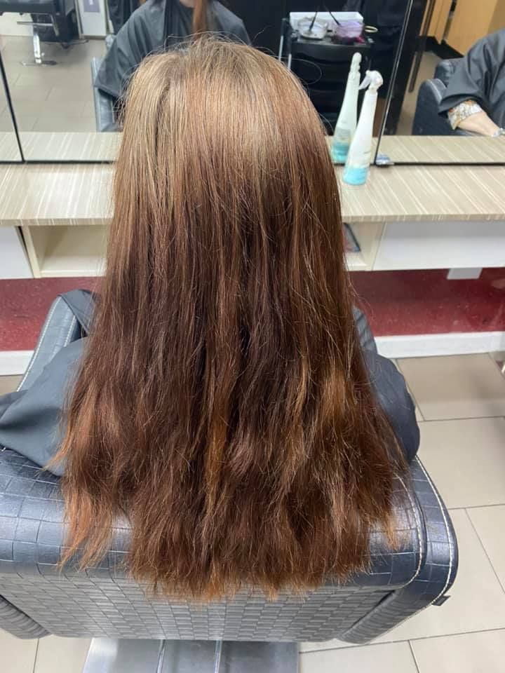 A Woman Is Sitting in A Chair with Her Hair in A Salon — Hair It Is In Balgownie, NSW