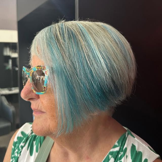 A Woman with Blue Hair and Sunglasses Is Wearing a Green and White Dress — Hair It Is In Balgownie, NSW