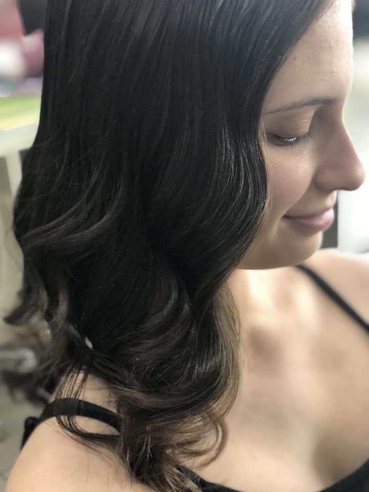 A Woman with Long Black Hair Is Wearing a Black Tank Top — Hair It Is In Balgownie, NSW