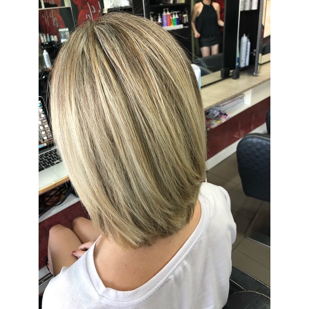 A Woman with Blonde Hair Is Sitting in A Chair in A Salon — Hair It Is In Balgownie, NSW