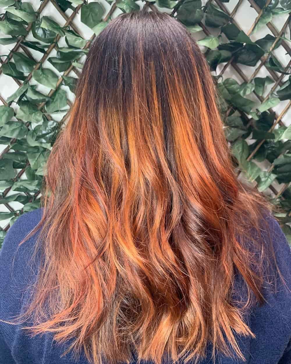 A Woman with Long Red Hair Is Standing in Front of A Hedge — Hair It Is In Balgownie, NSW