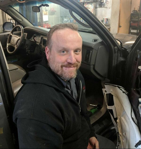Cody Technician Working Inside Vehicle Interior | Norm's Car Care