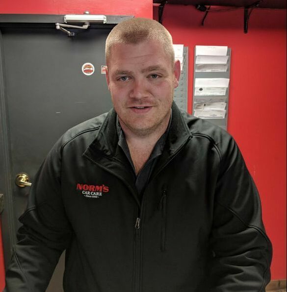 Ian Service Team Member Inside Auto Repair Facility | Norm's Car Care