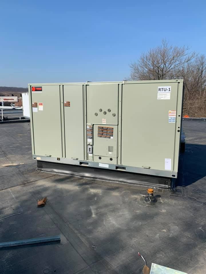 A large box is sitting on top of a roof.