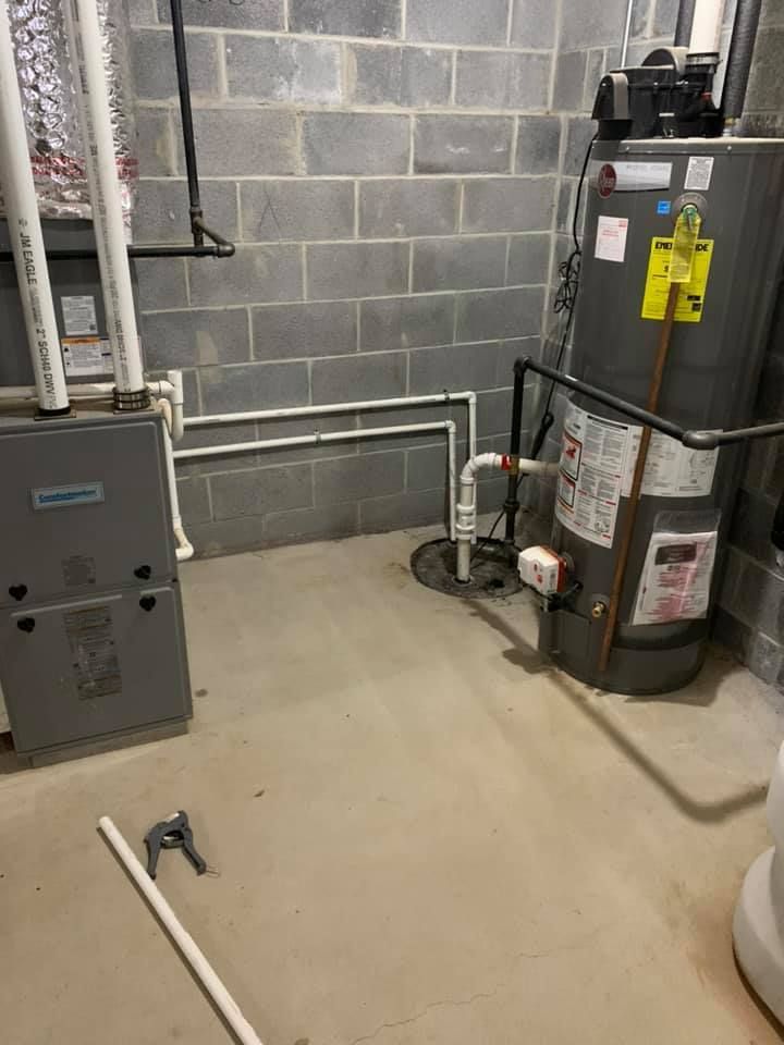 A basement with a water heater and a furnace.