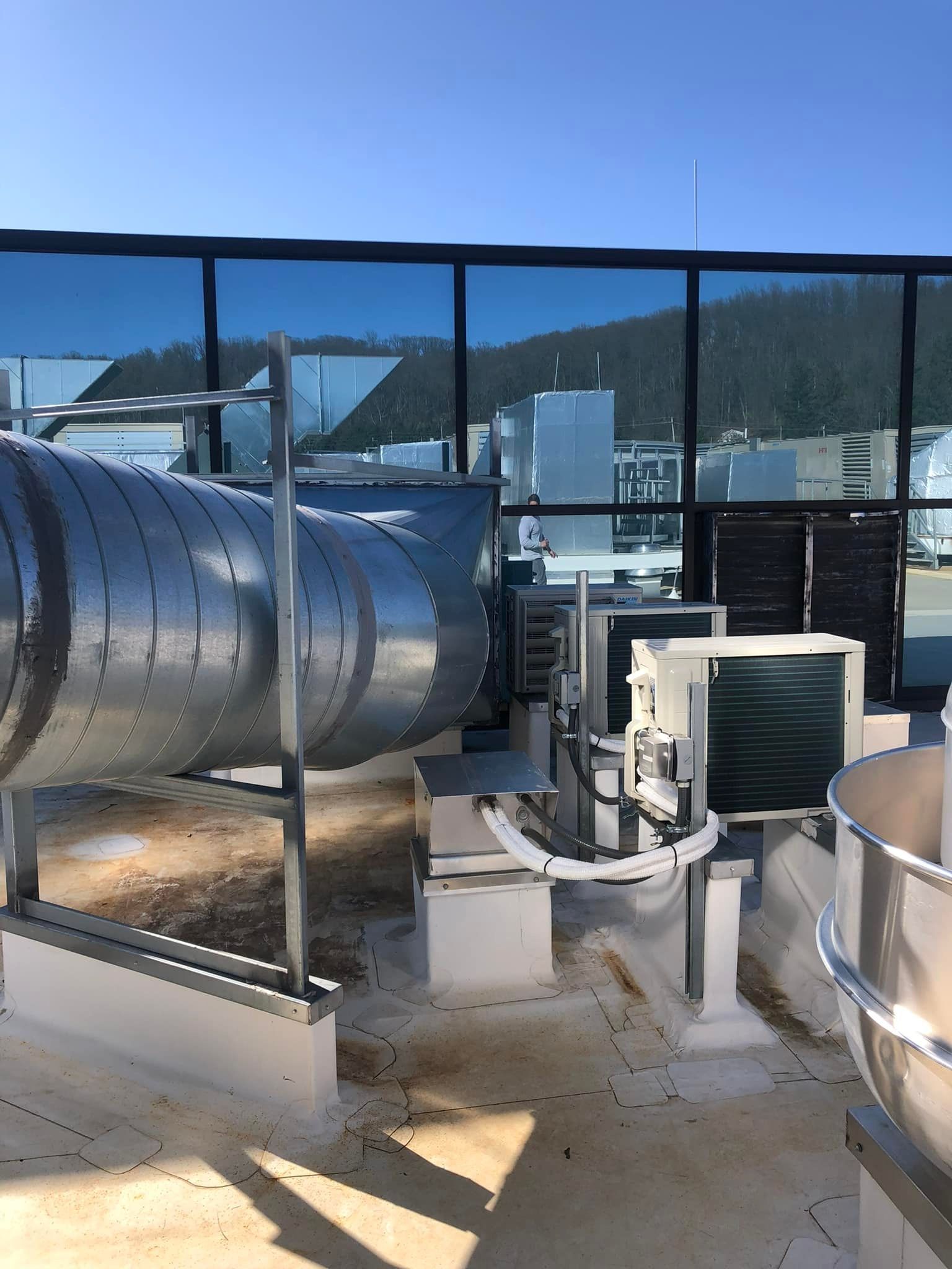 A rooftop with a lot of pipes and appliances on it