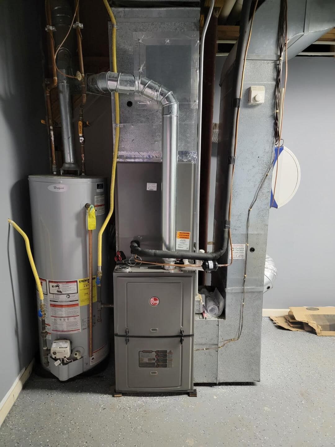 There is a water heater and a furnace in the basement.