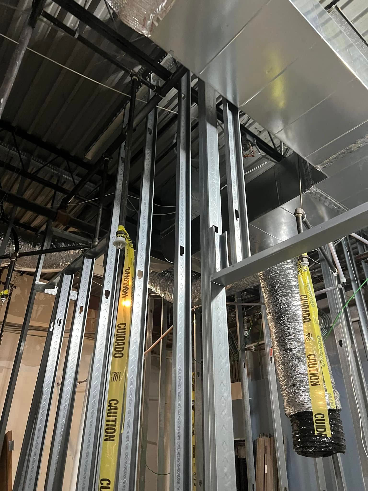 A metal structure is being built in a building.