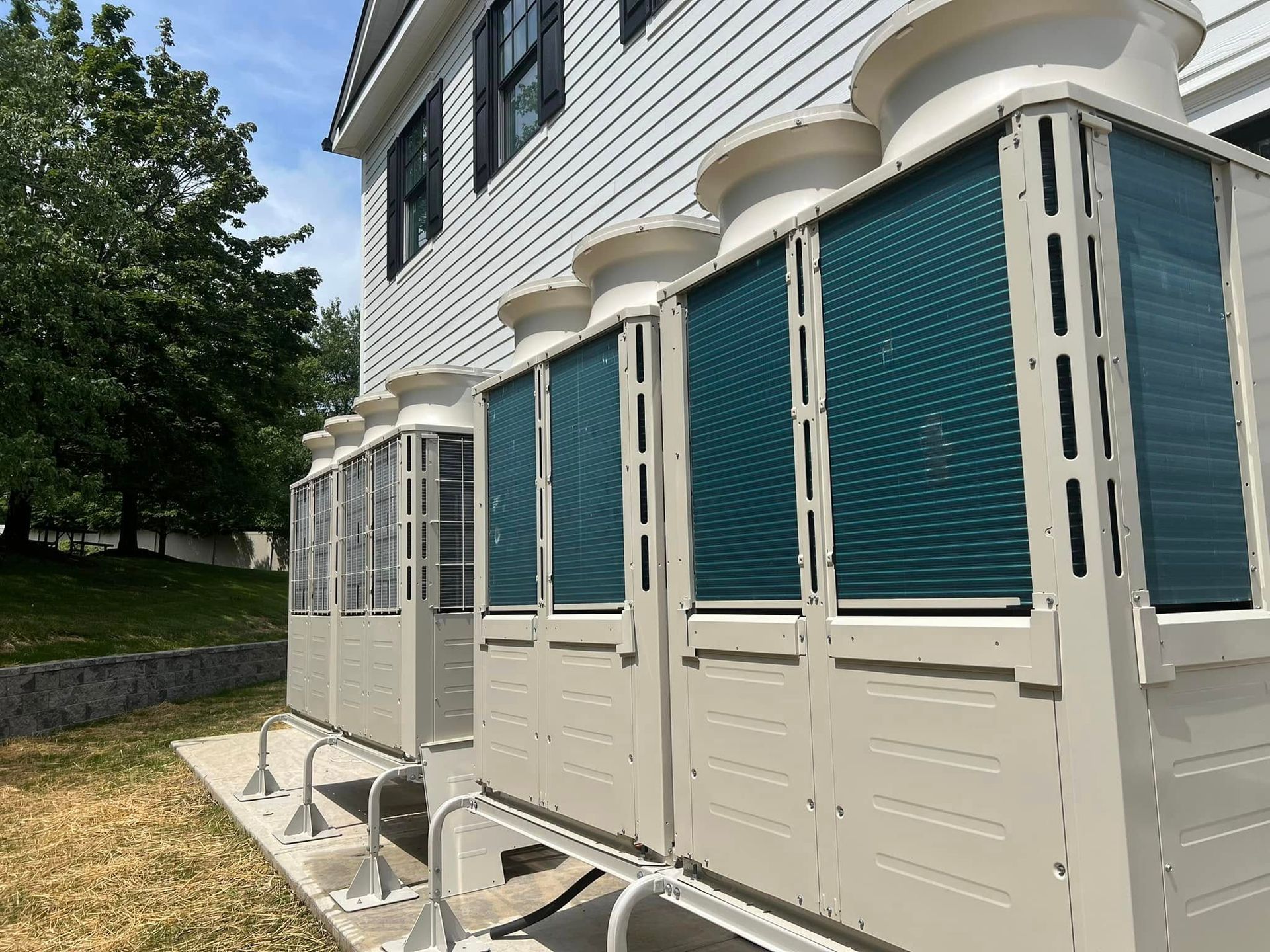 A building with a lot of air conditioners on the side of it