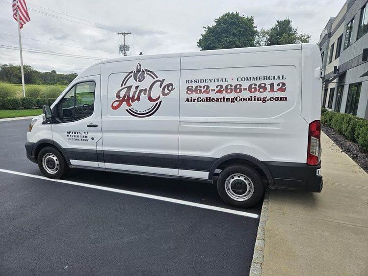 A white van is parked in a parking lot.